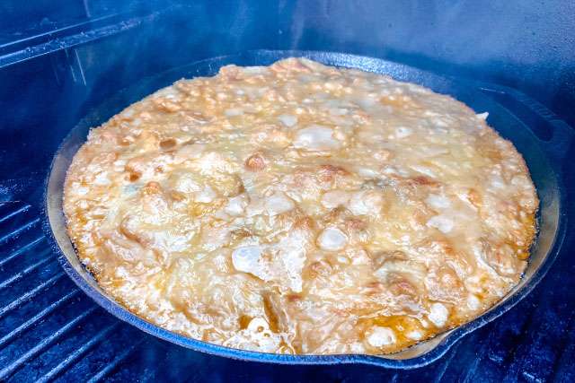 Smoked mac and cheese in cast iron skillet on pellet grill