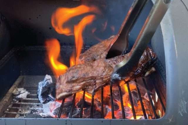 Grilling over the firebox fire with an offset smoker