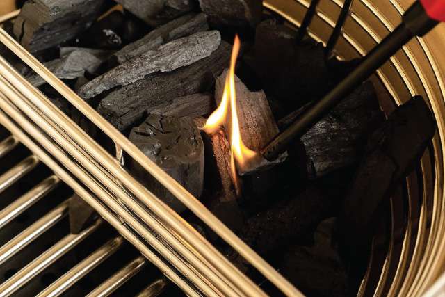 Lighting half a dome of charcoal in divided Series III basket