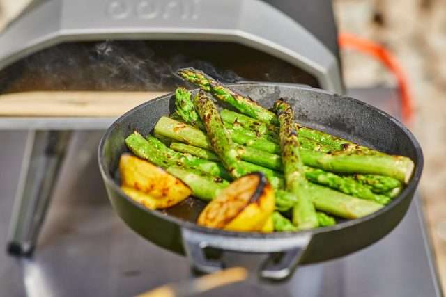 Grilling asparagus in the Ooni Koda 12 with a cast iron pan