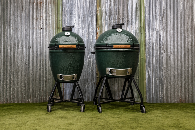 Big Green Eggs sitting in front of iron wall